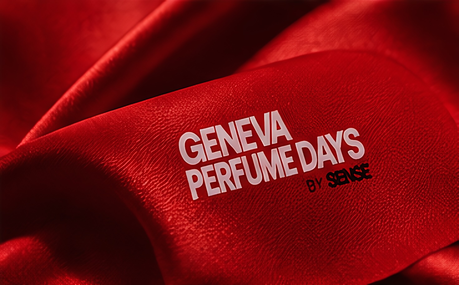 Un tissu rouge imprimé du logo Geneva Perfume Days
